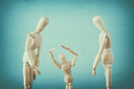 family violence cincept. wooden dummies as parents and child arguing and shoutingの写真素材