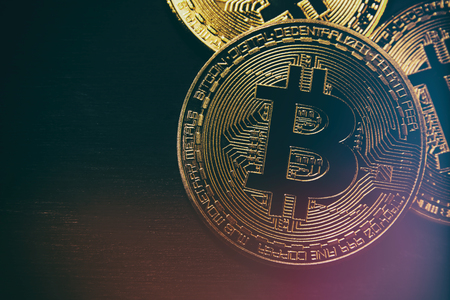 Golden Bitcoin over black background. Business concept