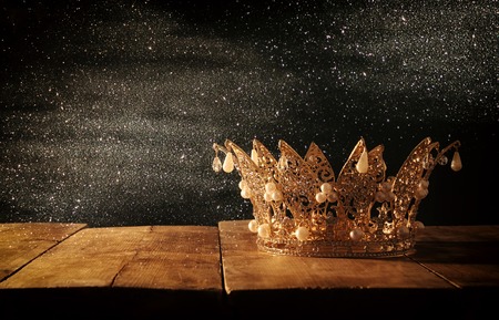 low key image of beautiful queen/king crown over wooden table. vintage filtered. fantasy medieval periodの写真素材