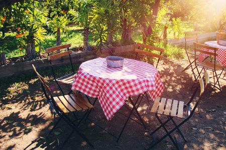 Image of rural restaurant with vintage table and chairs outdoorsの写真素材