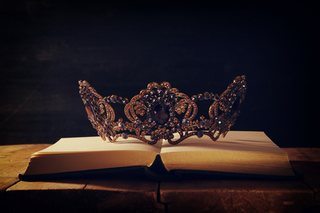 low key image of beautiful queen/king crown over wooden table. vintage filtered. fantasy medieval periodの写真素材