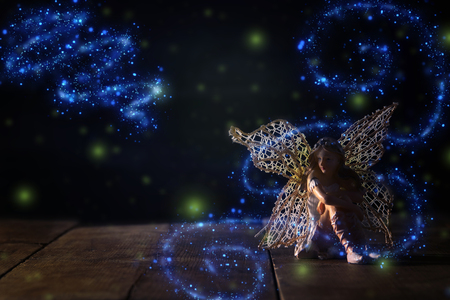 image of magical little fairy sitting on old wooden floorの写真素材