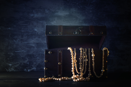 Image of mysterious opened old wooden treasure chest with light. An adventure and fantasy medieval period. Selective focusの写真素材