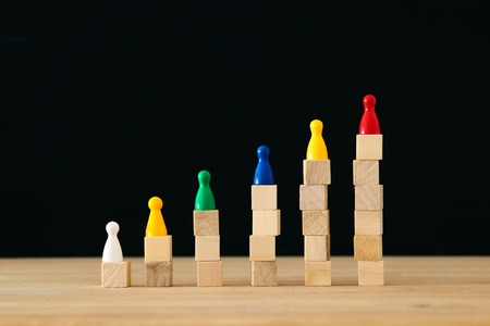 colorfull figures on woodn blocks. concept image of buliding a winning team. human resources and managementの写真素材