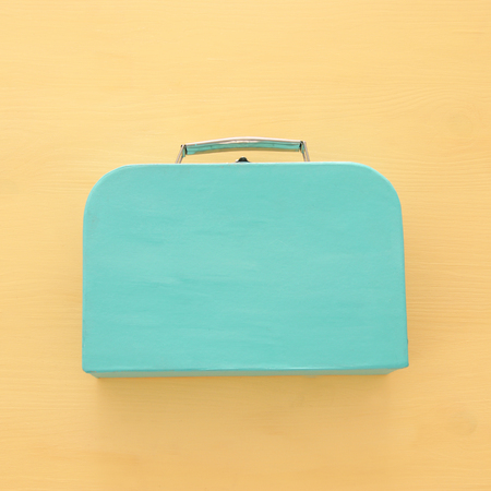 vacation and summer image of luggage over yellow wooden backgroundの写真素材