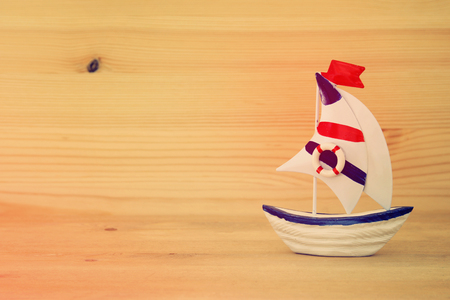 vacation and summer image with boat over wooden tableの写真素材