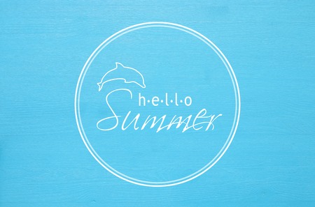 vacation and summer concept with text HELLO SUMMER over blue wooden background