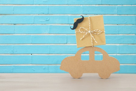 Image of wooden car with gift box on the roof, present for dad. Father's day conceptの写真素材