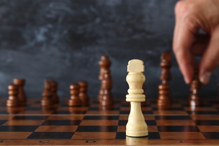 Image of businessman hand moving chess figure over chess board. Business, competition, strategy,...