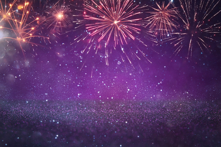 abstract gold and purple glitter background with fireworks. christmas eve, 4th of july holiday conceptの写真素材