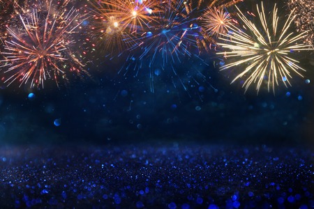 abstract gold, black and blue glitter background with fireworks. christmas eve, 4th of july holiday conceptの写真素材