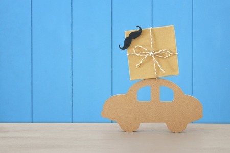 Image of wooden car with gift box on the roof, present for dad. Father's day conceptの写真素材