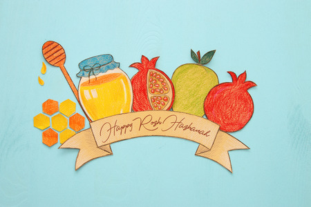 Rosh hashanah (jewish New Year holiday) concept. Traditional symbols shapes cut from paper and paintedの写真素材