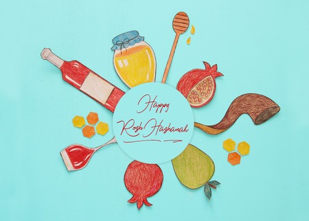 Rosh hashanah (jewish New Year holiday) concept. Traditional symbols shapes cut from paper and paintedの写真素材
