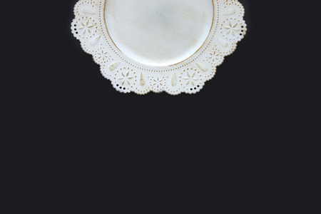 Top view of vintage white empty plate over black background. Flat layの写真素材