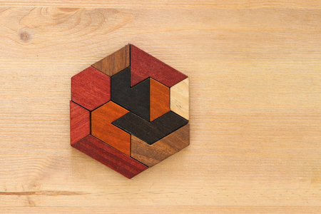 square tangram puzzle, over wooden table