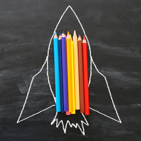 Back to school concept. rocket sketch and pencils over classroom blackboard backgroundの写真素材