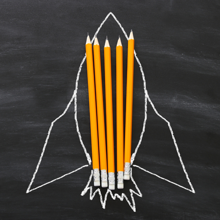 Back to school concept. rocket sketch and pencils over classroom blackboard backgroundの写真素材