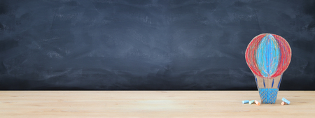 Back to school concept. cardboard handmade hot air balloon over classroom blackboard backgroundの写真素材