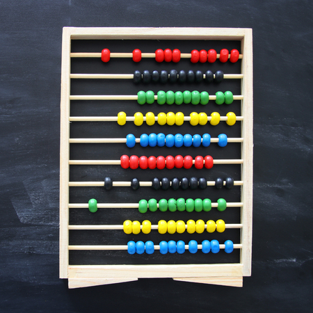 Top view of beaded Abacus over chalkboard backgroundの写真素材