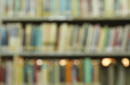 abstract background of blurred books in public library. retro style, image is blurredの写真素材