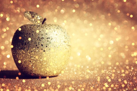 Rosh hashanah (jewish New Year holiday) concept. Traditional symbol, decorative glitter gold appleの写真素材
