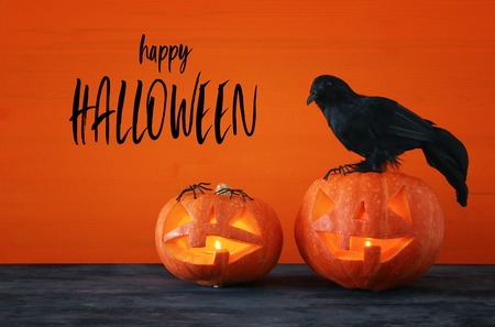 Halloween holiday concept. Pumpkins over wooden tableの写真素材