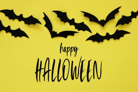 Halloween holiday concept. Black bats over yellow background. Top view, flat layの写真素材