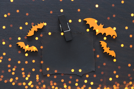 Halloween holiday minimal top view image of empty letter to add text over wooden background. Card and invitation concept. Glitter overlayの写真素材