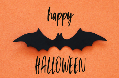 Halloween holiday concept. Black bats over orange background. Top view, flat layの写真素材