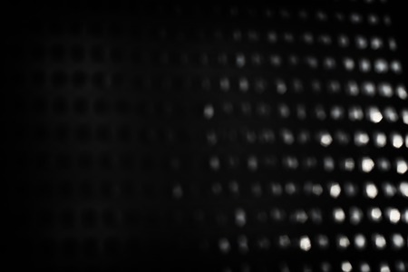 Abstract background of black and silver bokeh lightsの写真素材
