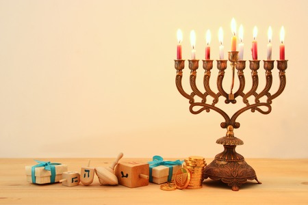 Image of Jewish holiday Hanukkah background with traditional spinning top, menorah (traditional candelabra) and burning candlesの写真素材
