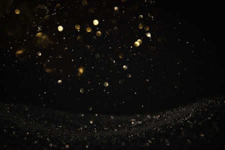 Glitter vintage lights background. Black and gold. De-focused.の写真素材