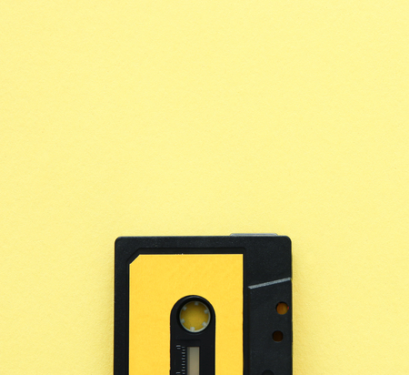 Retro cassette tape over yellow background. top view. copy spaceの写真素材