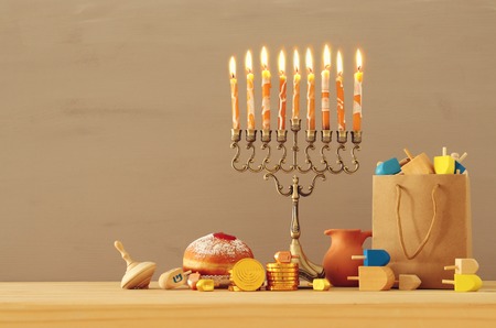 Image of Jewish holiday Hanukkah background with traditional spinning top, menorah (traditional candelabra) and burning candlesの写真素材