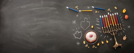 Banner of Jewish holiday Hanukkah background with traditional spinning top, menorah (traditional candelabra) and burning candlesの写真素材