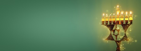 Banner of jewish holiday Hanukkah background with menorah (traditional candelabra) and burning candlesの写真素材