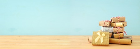 banner of handmade wrapped gift boxes over wooden tableの写真素材
