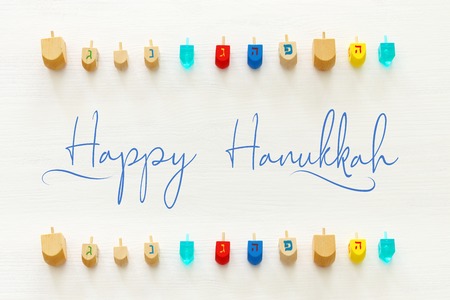 Image of jewish holiday Hanukkah with wooden dreidels colection (spinning top) over white backgroundの写真素材