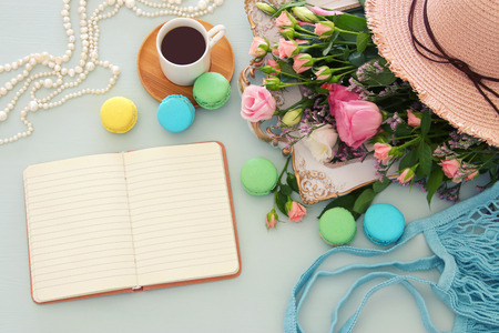 Plate of macaroons over wooden table coffee, empty table and flowers.の写真素材