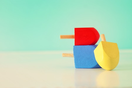 Image of Jewish holiday Hanukkah with wooden dreidels collection (spinning top).