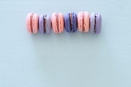 Top view of colorful macaron or macaroon over pastel blue background. Flat layの写真素材