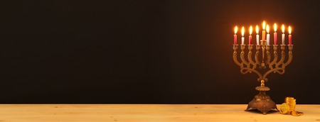 Image of Jewish holiday Hanukkah background with menorah (traditional candelabra) and candles