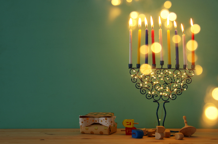 image of jewish holiday Hanukkah background with menorah (traditional candelabra) and colorful candlesの写真素材