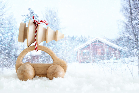 Wooden car carrying a christmas tree in front of dreamy and abstract magical winter landscapeの写真素材