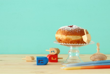 Image of jewish holiday Hanukkah with traditional doughnut on the tableの写真素材