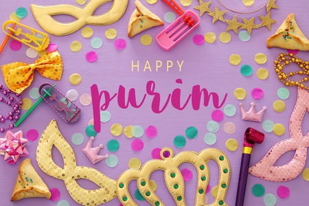 Purim celebration concept (jewish carnival holiday) over purple, pink wooden background. Top viewの写真素材