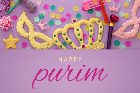 Purim celebration concept (jewish carnival holiday) over purple, pink wooden background. Top viewの写真素材
