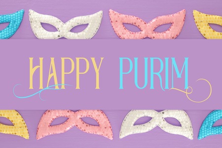 Purim celebration concept (jewish carnival holiday) over purple, pink wooden background. Top viewの写真素材