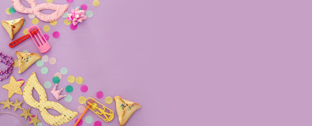 Purim celebration concept (Jewish carnival holiday) over purple, pink wooden background. Top viewの写真素材